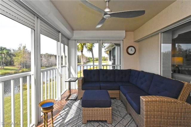 sunroom with a water view, a healthy amount of sunlight, and ceiling fan