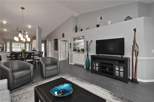 living room with a chandelier and vaulted ceiling