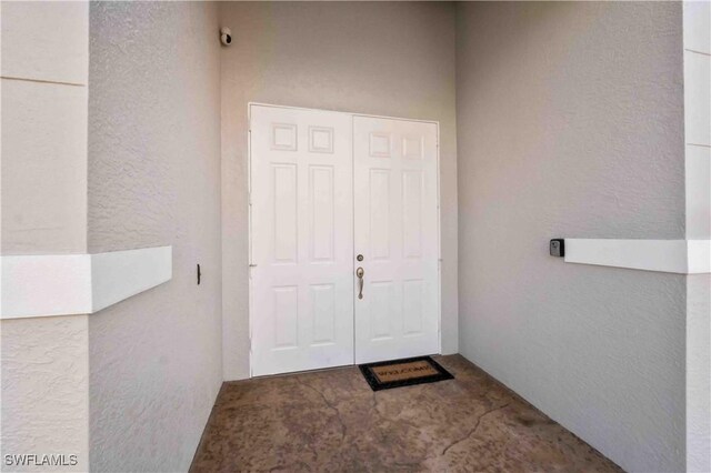 106 SE 5th St, Cape Coral, FL 33990 - doorway to property with stucco siding