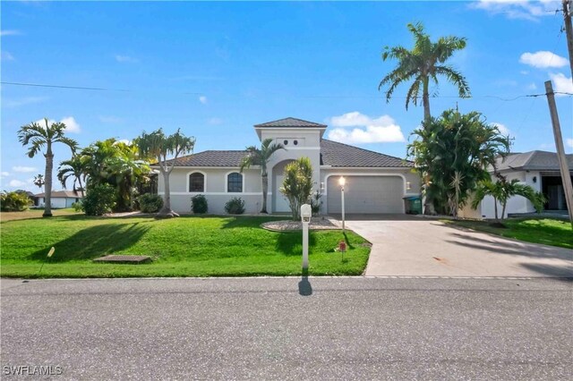 106 SE 5th St, Cape Coral, FL 33990 - mediterranean / spanish-style house featuring a garage, driveway, a front yard, and stucco siding