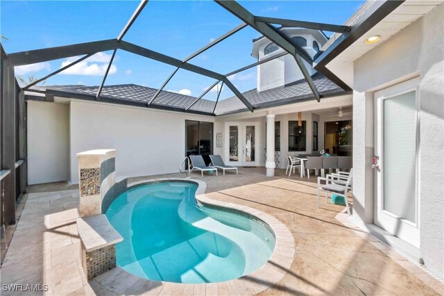 106 SE 5th St, Cape Coral, FL 33990 - outdoor pool featuring french doors, a patio, and a lanai