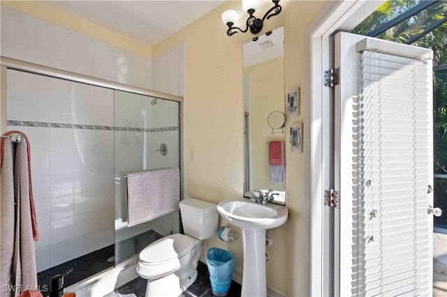 106 SE 5th St, Cape Coral, FL 33990 - bathroom featuring a shower stall, toilet, and a sink