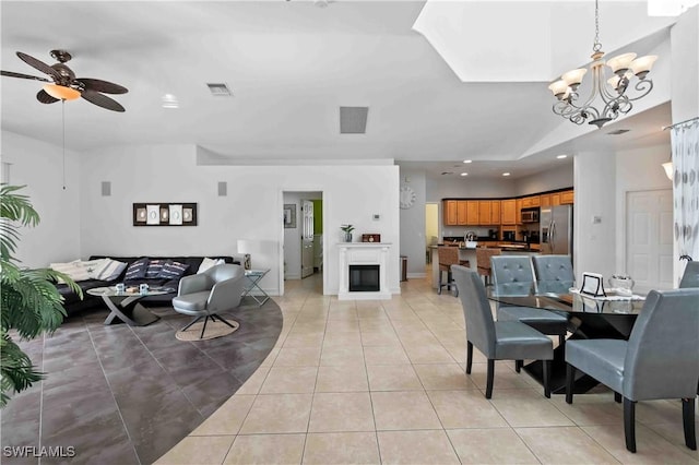 106 SE 5th St, Cape Coral, FL 33990 - dining area with recessed lighting, light tile patterned floors, a chandelier, a ceiling fan, and a glass covered fireplace