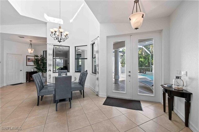 106 SE 5th St, Cape Coral, FL 33990 - dining room with french doors, light tile patterned floors, a chandelier, and baseboards