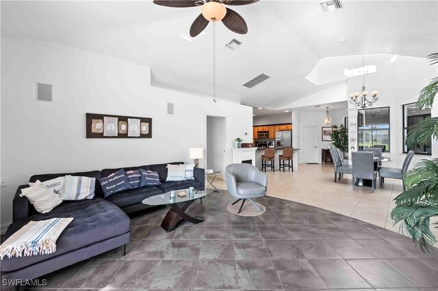 106 SE 5th St, Cape Coral, FL 33990 - living area featuring a chandelier, a ceiling fan, vaulted ceiling, and light tile patterned flooring