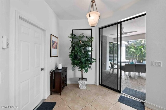 106 SE 5th St, Cape Coral, FL 33990 - foyer entrance with ceiling fan, light tile patterned flooring, and baseboards