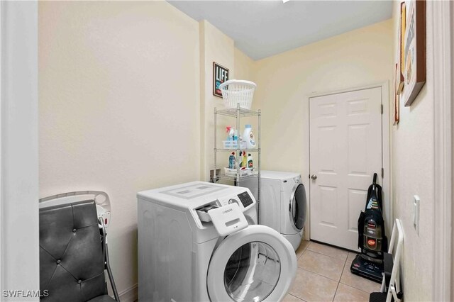 106 SE 5th St, Cape Coral, FL 33990 - laundry area featuring washer and clothes dryer and light tile patterned floors
