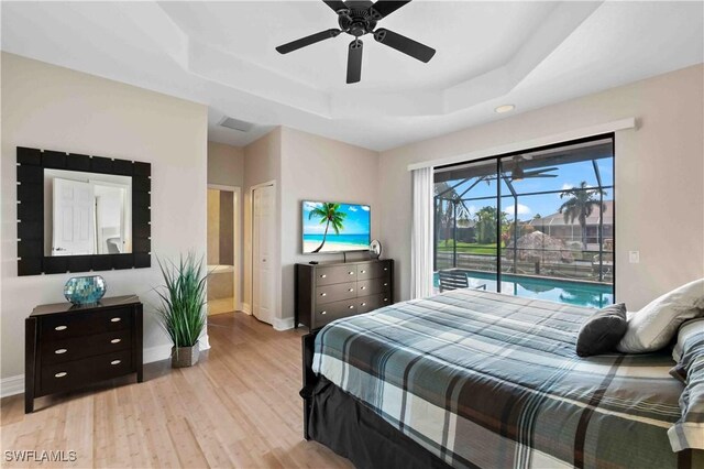106 SE 5th St, Cape Coral, FL 33990 - bedroom with access to exterior, a raised ceiling, wood finished floors, and baseboards