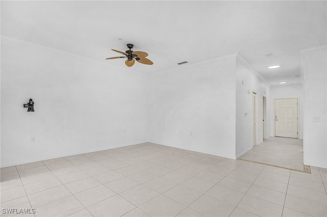 spare room featuring ceiling fan, light tile patterned floors, and ornamental molding