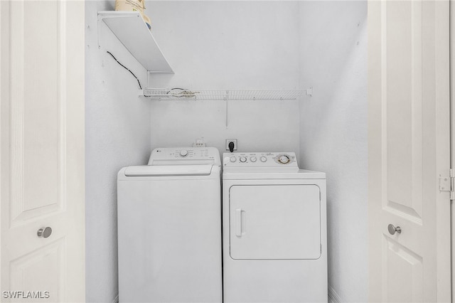 washroom with washer and dryer