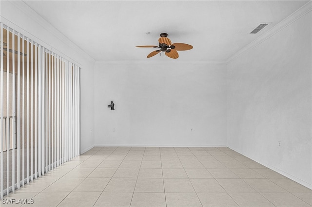 tiled empty room with ceiling fan and crown molding