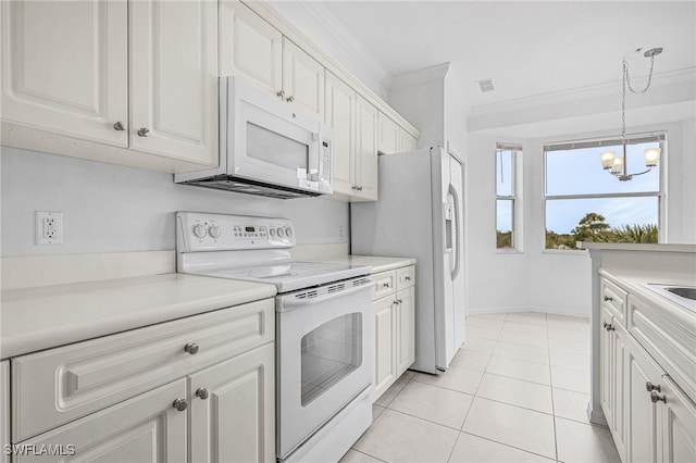 kitchen featuring light tile patterned floors, a notable chandelier, white appliances, ornamental molding, and white cabinets