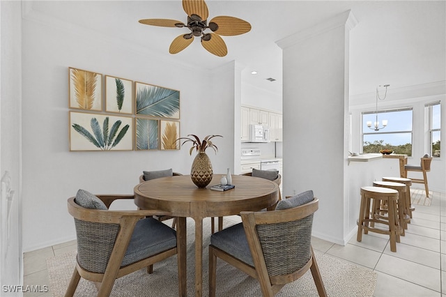 dining area featuring ceiling fan with notable chandelier, light tile patterned floors, and crown molding