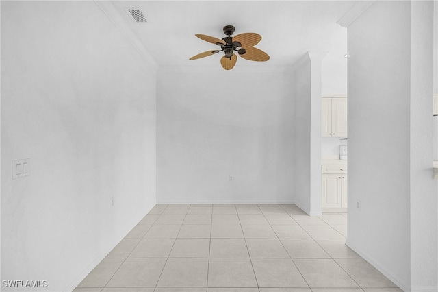 tiled spare room with ceiling fan and ornamental molding