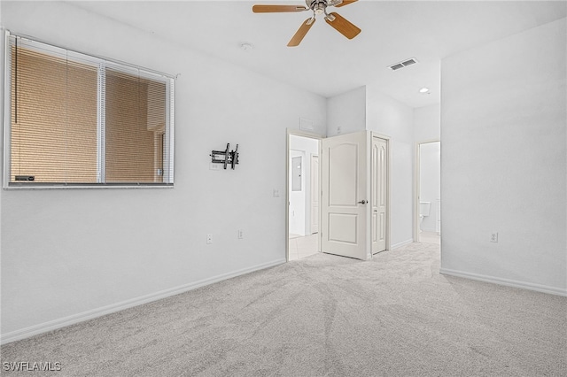 unfurnished room with ceiling fan and light colored carpet