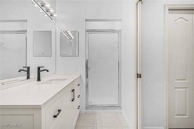 bathroom featuring vanity, tile patterned flooring, and walk in shower