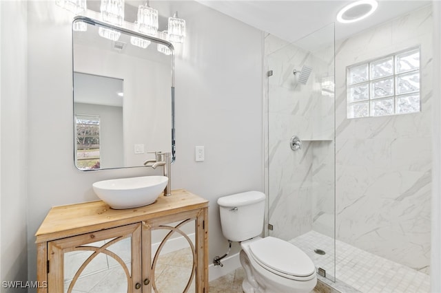 bathroom featuring an enclosed shower, vanity, and toilet