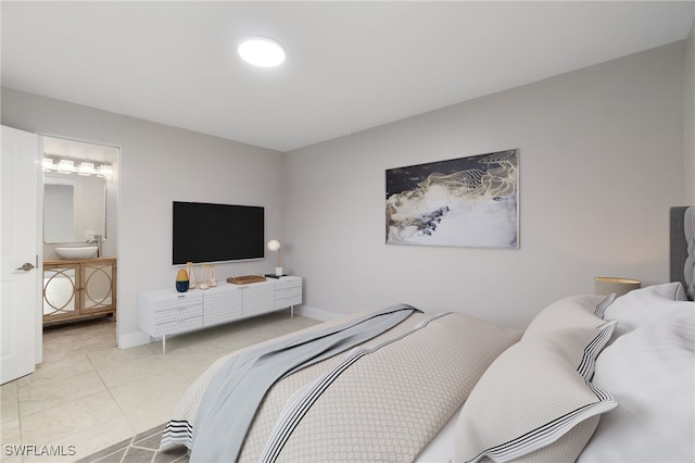 bedroom featuring ensuite bath and light tile patterned floors