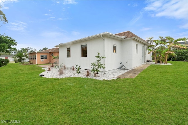 rear view of property with a lawn