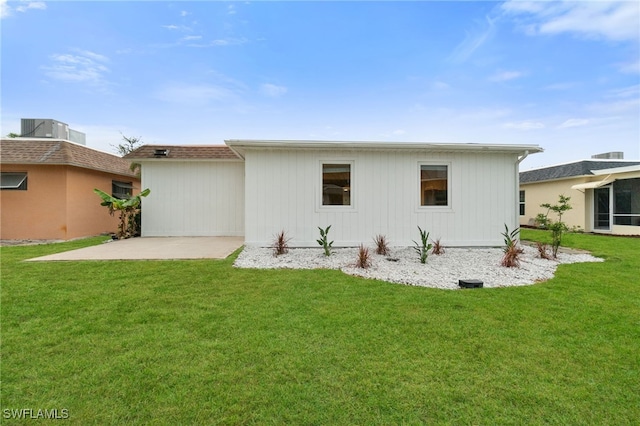 back of property featuring a yard, a patio area, and central air condition unit