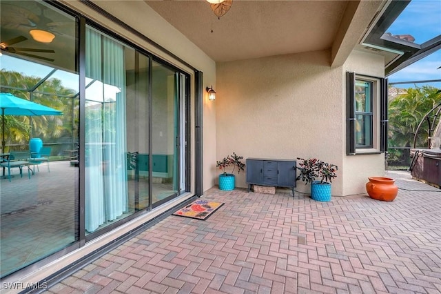 view of patio featuring glass enclosure