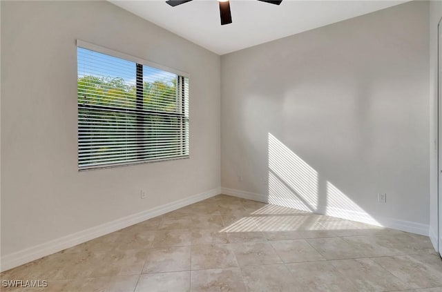 unfurnished room with ceiling fan and light tile patterned floors