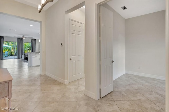 hall with light tile patterned floors