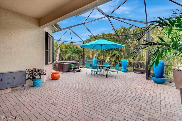 view of patio featuring a hot tub and glass enclosure