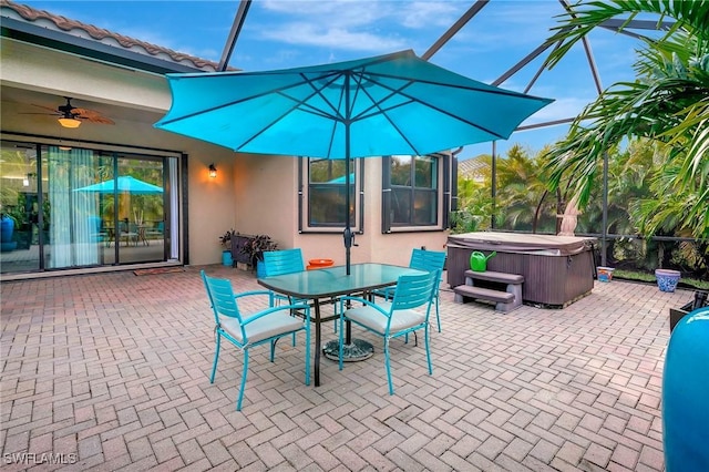 view of patio featuring a lanai and a hot tub