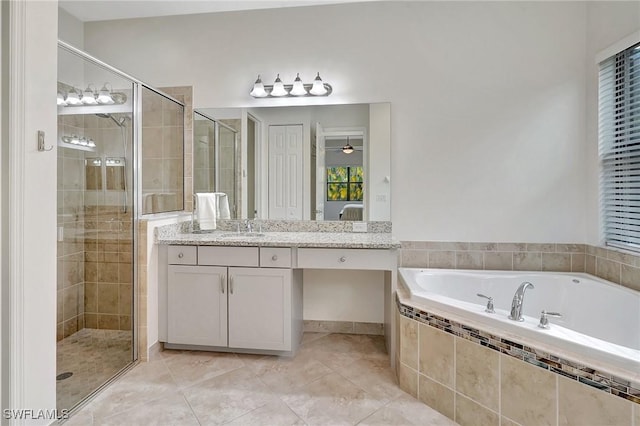 bathroom featuring shower with separate bathtub, tile patterned floors, and vanity