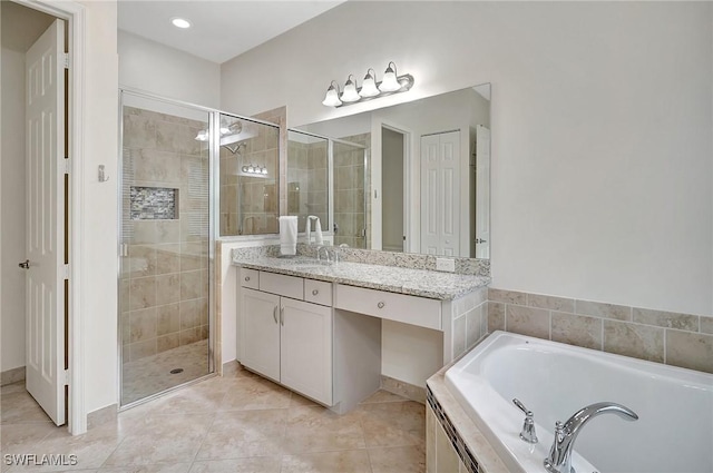 bathroom featuring independent shower and bath, tile patterned floors, and vanity