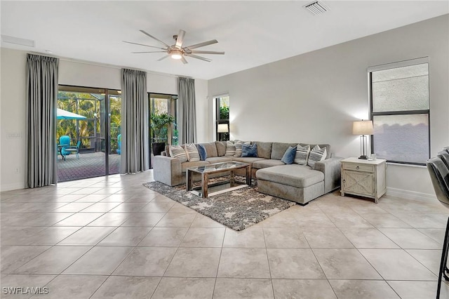 living room with ceiling fan and light tile patterned floors