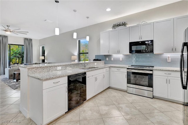 kitchen featuring decorative light fixtures, black appliances, kitchen peninsula, sink, and white cabinets