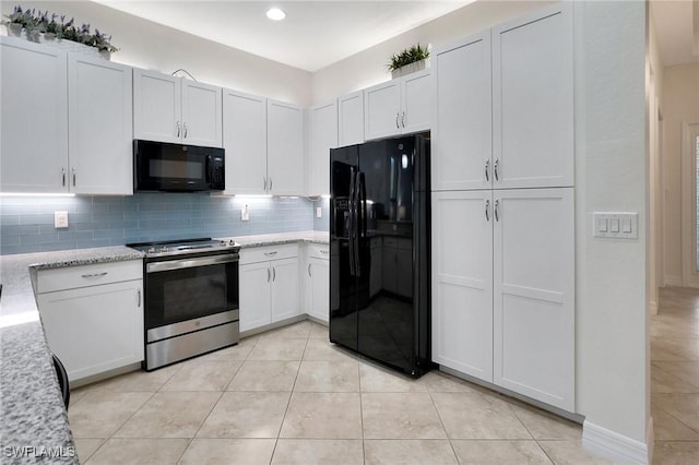 kitchen featuring tasteful backsplash, white cabinetry, light stone countertops, and black appliances