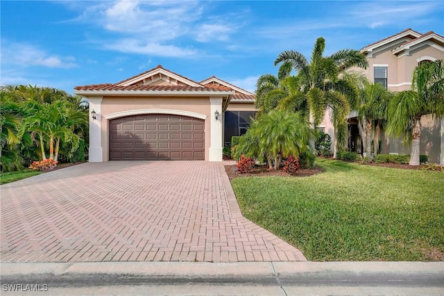 mediterranean / spanish home featuring a garage and a front lawn