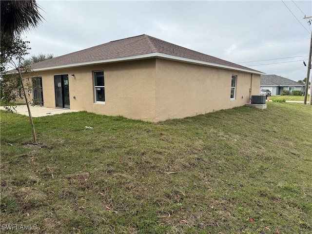 view of home's exterior with a patio area, cooling unit, and a lawn