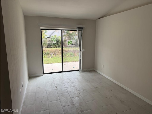 spare room with vaulted ceiling