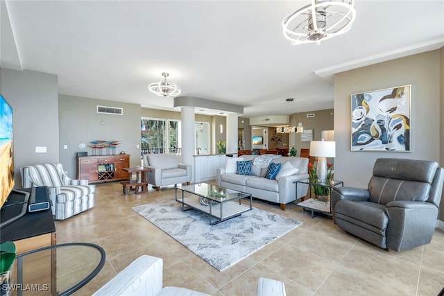 tiled living room featuring ceiling fan with notable chandelier