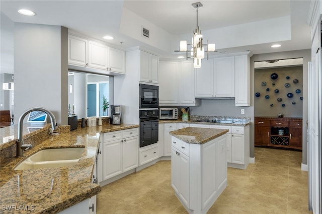 kitchen with sink, white cabinets, black appliances, and stone counters