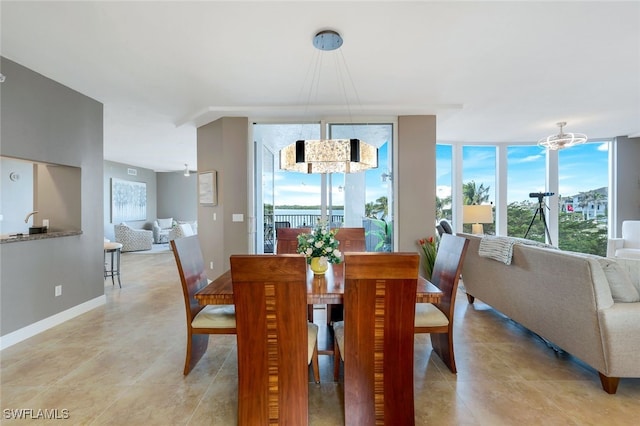 dining room featuring expansive windows and a notable chandelier