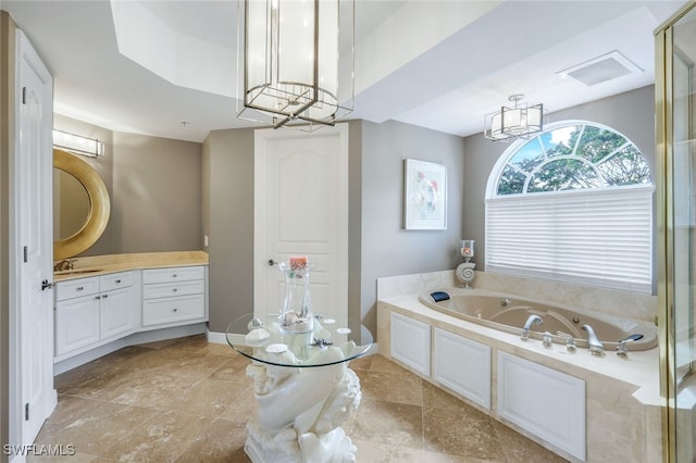 bathroom featuring a washtub, vanity, and a notable chandelier