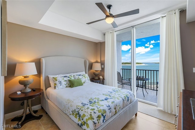 bedroom featuring ceiling fan, access to exterior, a water view, and light tile patterned flooring