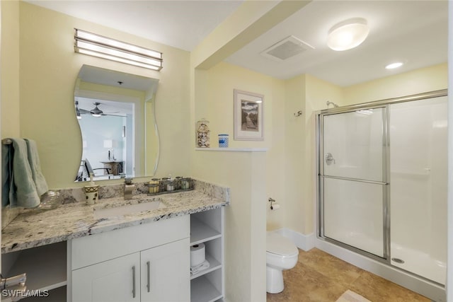 bathroom featuring ceiling fan, an enclosed shower, vanity, and toilet