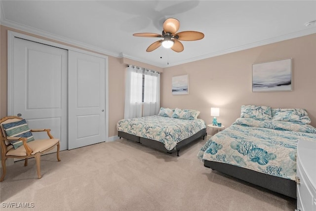 bedroom featuring crown molding, light carpet, ceiling fan, and a closet