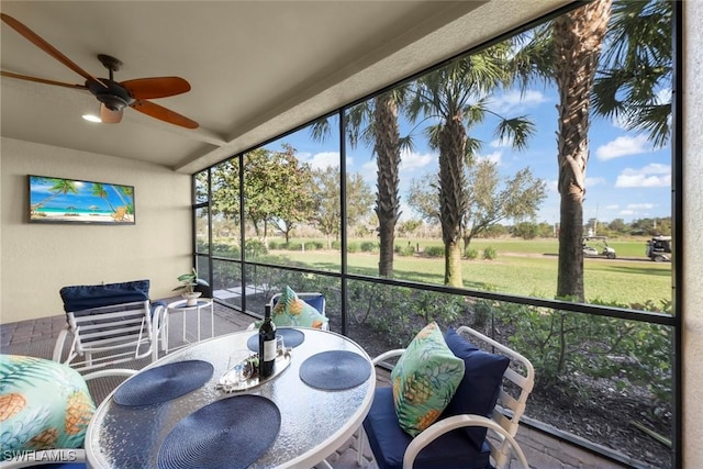 sunroom / solarium featuring ceiling fan