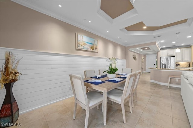 tiled dining space featuring crown molding and wood walls