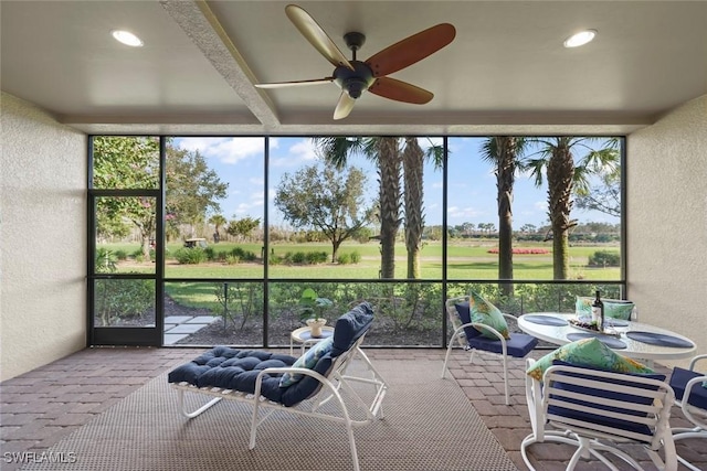 unfurnished sunroom with plenty of natural light and ceiling fan