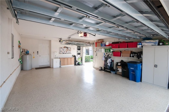 garage featuring electric panel, water heater, and a garage door opener