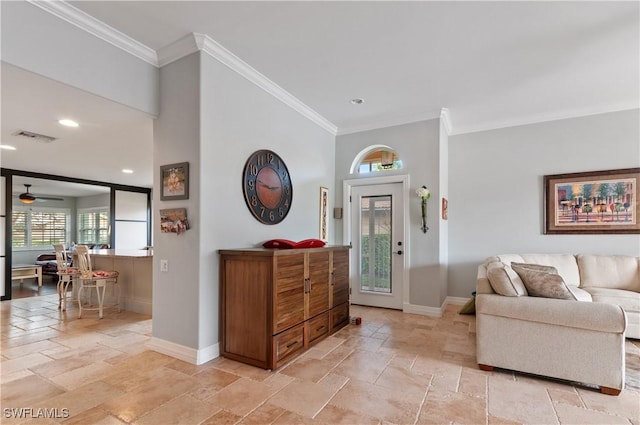 entrance foyer featuring ceiling fan and ornamental molding