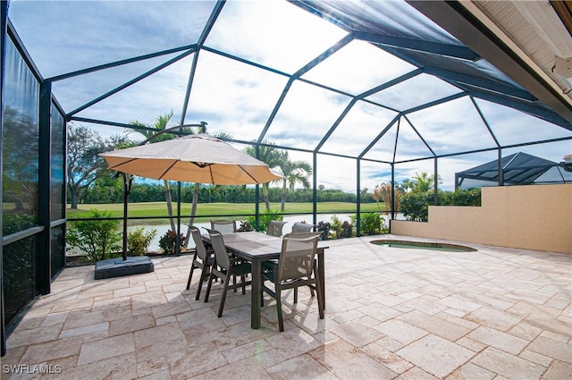 view of patio featuring a water view, a jacuzzi, and glass enclosure